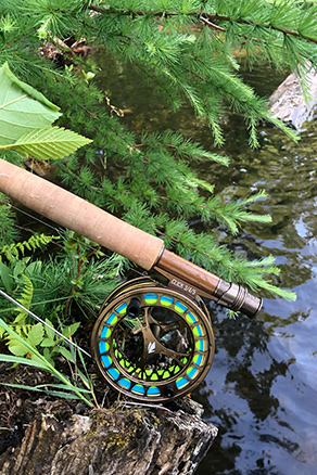 fly rod on riverbank